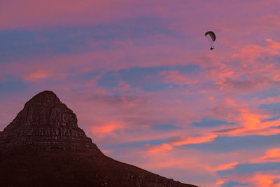 Low angle view of silhouette bird flying against sky during sunset