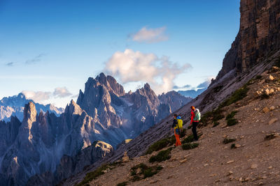 Hikers on the mountain path in the 3 cime natural park dolomites, italy