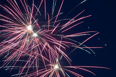 Low angle view of firework display at night