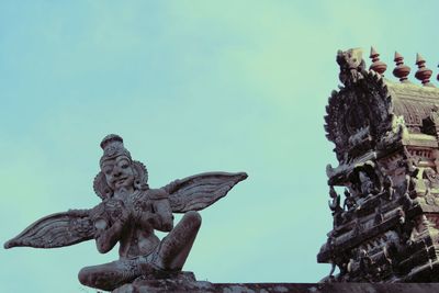 Low angle view of angel statue against sky