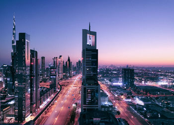 High angle view of city street and buildings against sky