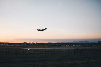 Low angle view of airplane flying against clear sky