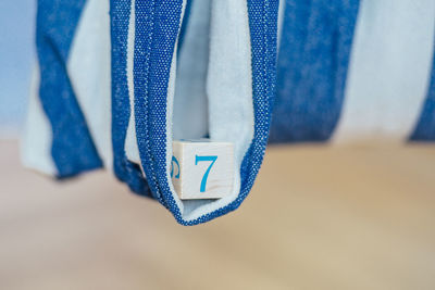 Close-up of clothes hanging on blue fabric