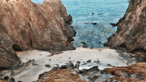 High angle view of rocks on sea shore