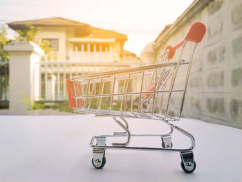 Close-up of trolley against house