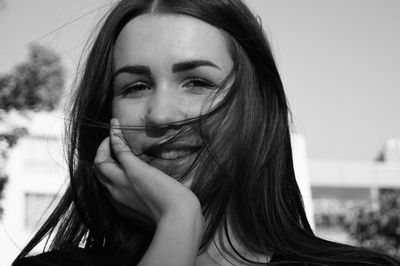 Close-up portrait of young woman in city