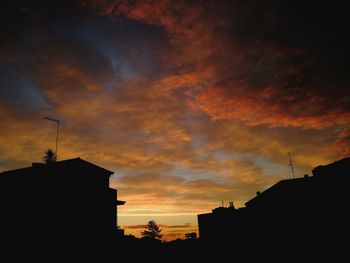 Low angle view of silhouette buildings against sky during sunset