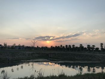 Scenic view of lake against sky during sunset