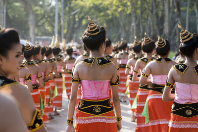 Rear view of people standing outdoors