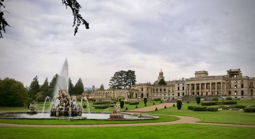 View of garden against cloudy sky