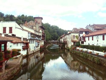 Bridge over river with buildings in background