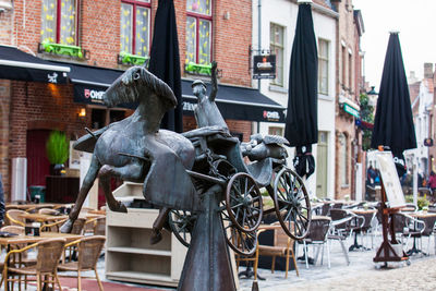 Close-up of sculpture against buildings in city