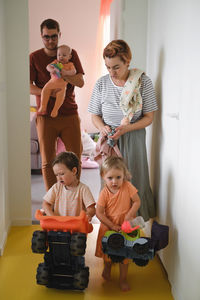 Big family going for a walk. candid moment at home when kids collecting toys for outdoor games