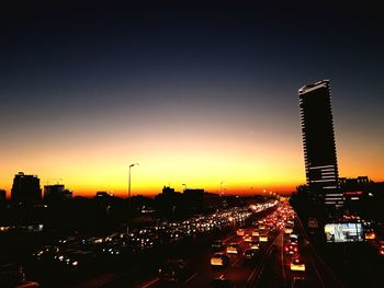 Illuminated cityscape against sky at night