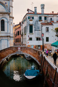 Elderly couple on characteristic bridge in the historic center of the lagoon city of venice