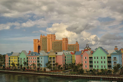 Buildings in city against cloudy sky