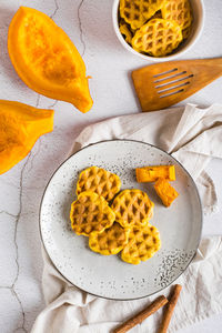 Belgian homemade pumpkin waffles on a plate on the table. autumn baking. top and vertical view