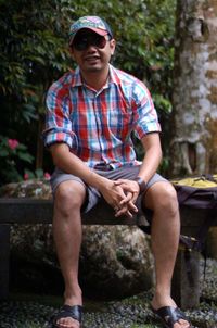 Young man sitting on rock