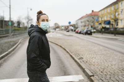 Woman wearing face mask looking away