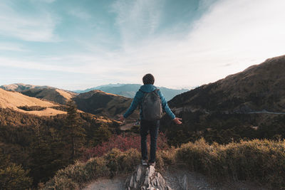 Rear view of man standing on cliff