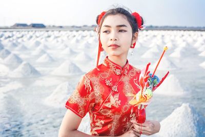 Portrait of beautiful woman standing on beach