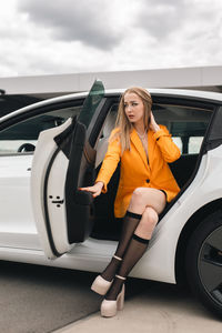 Portrait of smiling young woman sitting in car