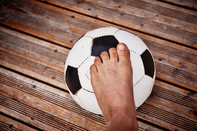 Low section of man on soccer ball