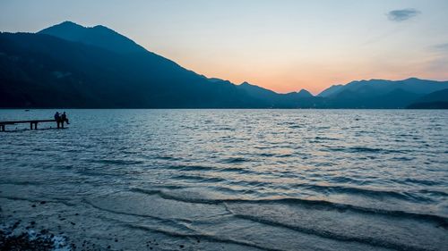 Scenic view of lake against sky during sunset