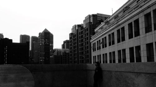 Buildings in city against clear sky