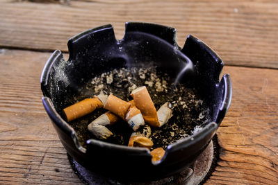 Close-up of cigarette smoking on table