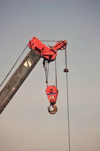 Low angle view of crane against clear sky