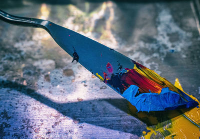 High angle view of multi colored water on metal