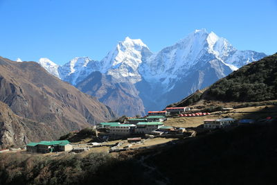 Panoramic view of mountains against clear blue sky