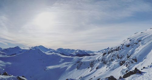 Scenic view of snow covered mountains against sky