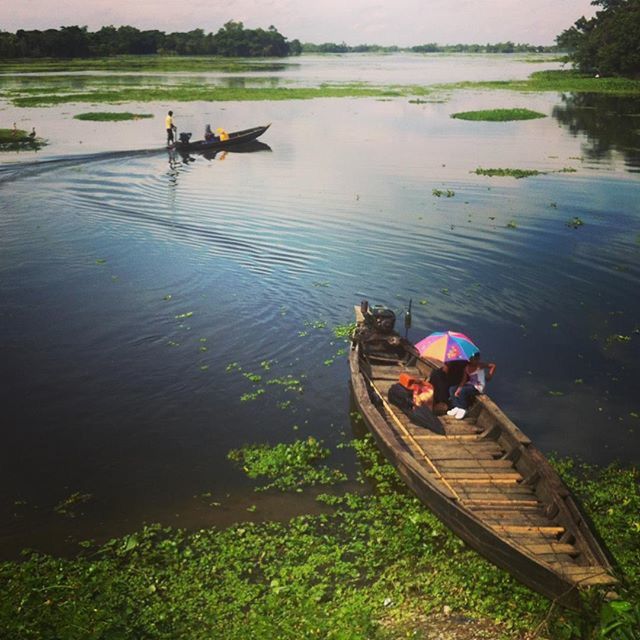 water, lifestyles, transportation, leisure activity, people, mode of transport, lake, nautical vessel, boat, river, high angle view, sitting, reflection, togetherness, grass, nature, riverbank