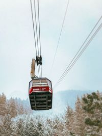 Overhead cable car against sky during winter