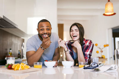 Young couple having breakfast in the kitchen