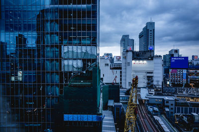 Modern buildings in city against sky