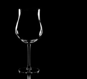 Close-up of wine glass against black background