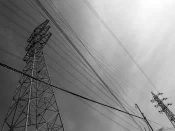 Low angle view of electricity pylon against sky