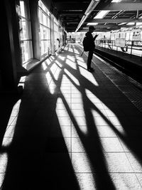 Shadow of man on tiled floor
