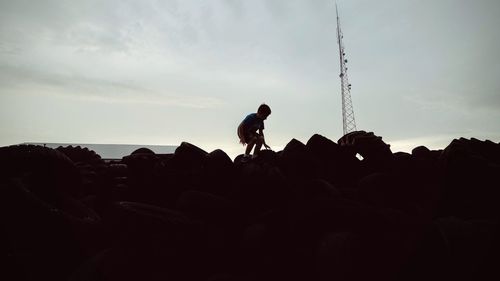 Silhouette of tourists on rock