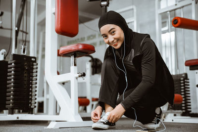 Young woman exercising in gym