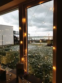 Illuminated sea seen through glass window