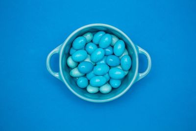 Directly above shot of blue candies in bowl