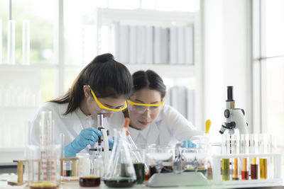 Two scientists performing experiment in laboratory