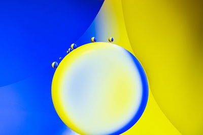 Close-up of multi colored balloons against blue sky