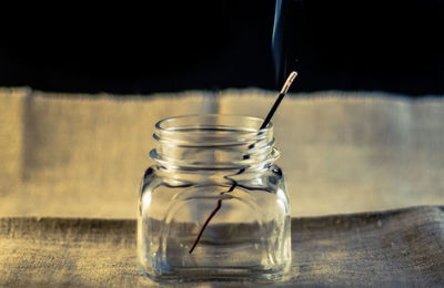 Close-up of incense in jar