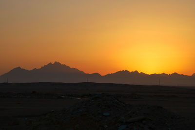 Scenic view of silhouette mountains against sky during sunset