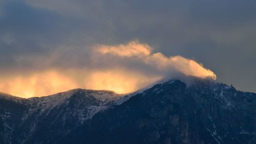 Scenic view of snowcapped mountains against sky during sunset
